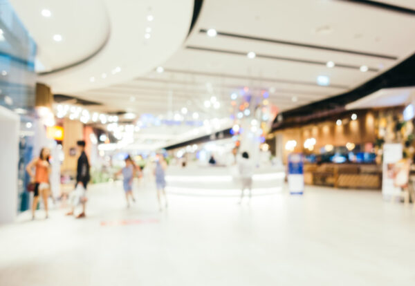 Abstract blur and bokeh defocused shopping mall interior of department store for background